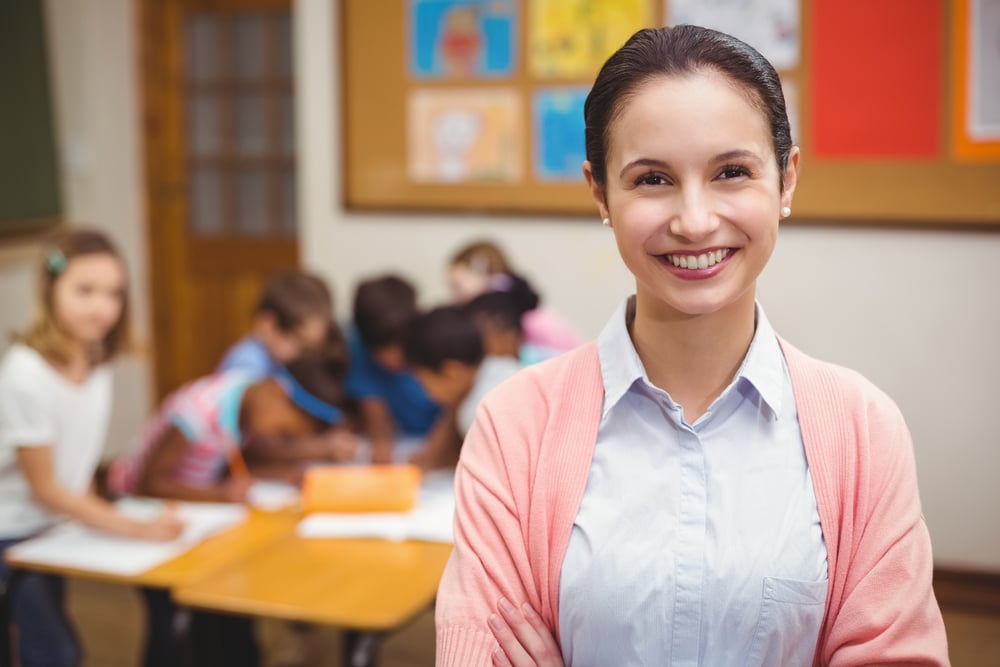 Teacher smiling at camera in classroom at the elementary school-1